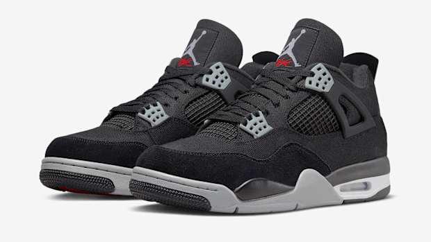 View of black and grey Air Jordan 4 shoes.
